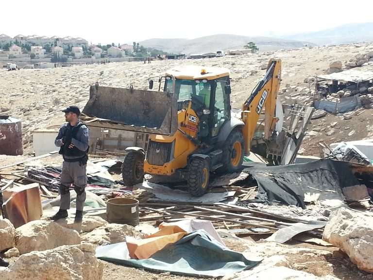 JCB vehicle demolishing buildings